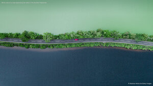 Aerial view of a road separating two lakes in the Scottish Highlands