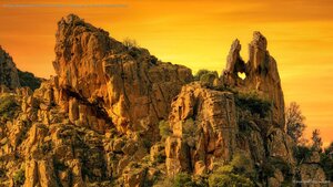 A heart-shaped hole in the rock formation of Calanques de Piana in Corsica, France