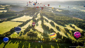 Hot air balloons over a golf course during the Bristol International Balloon Fiesta