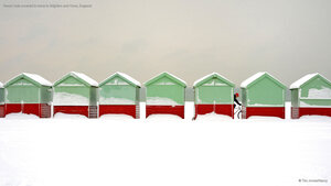Beach huts covered in snow in Brighton and Hove, England