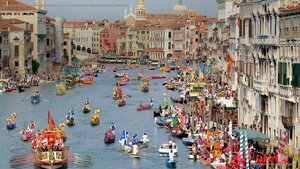 Boaters in historical dress row down the Grand Canal during the Regata Storica in Venice, Italy