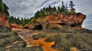 Caves and coastal features at low tide on the Bay of Fundy, near St. Martins, New Brunswick, Canada