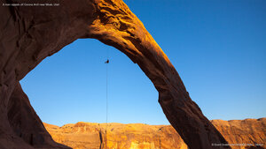 A man rappels off Corona Arch near Moab, Utah