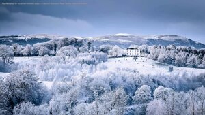Families play on the snow-covered slopes at Barnett Demesne Park, Belfast, Northern Ireland