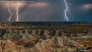 Rock formations in Badlands National Park during a lightning storm, South Dakota