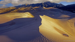 Sand dunes with Sangre de Cristo Mountains in the background, Great Sand Dunes National Park and Preserve, Colorado