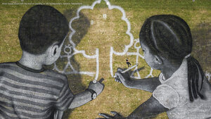 Artist Saype poses with his land art painting at UN Headquarters, Geneva, Switzerland