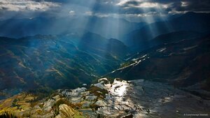 Sunlight reflecting on rice paddy terraces, Yuanyang County, China