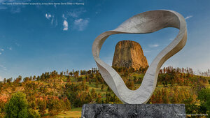 The 'Circle of Sacred Smoke' sculpture by Junkyu Muto frames Devils Tower in Wyoming