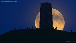 The moon rises over Glastonbury Tor, England