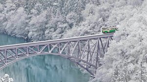 Train crossing the Tadami River near the village of Mishima in Japan