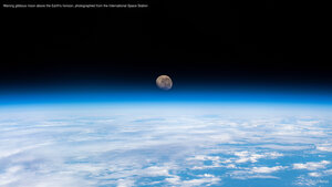 Waning gibbous moon above the Earth's horizon, photographed from the International Space Station