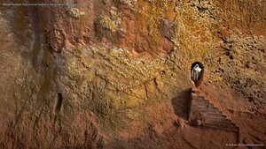 Woman emerges from a tunnel leading to Bet Amanuel, in Lalibela, Ethiopia