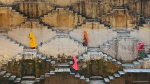 Women climbing a stepwell near Amber Fort in Jaipur, Rajasthan, India